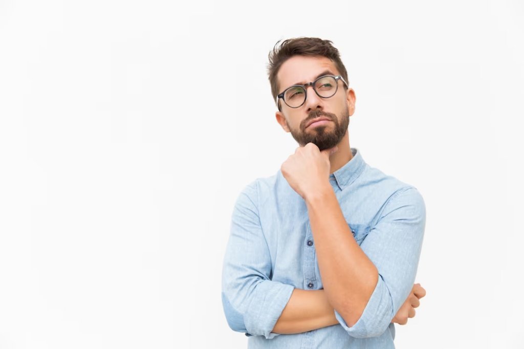 A Man with hand on chin, looking to the side in thought.